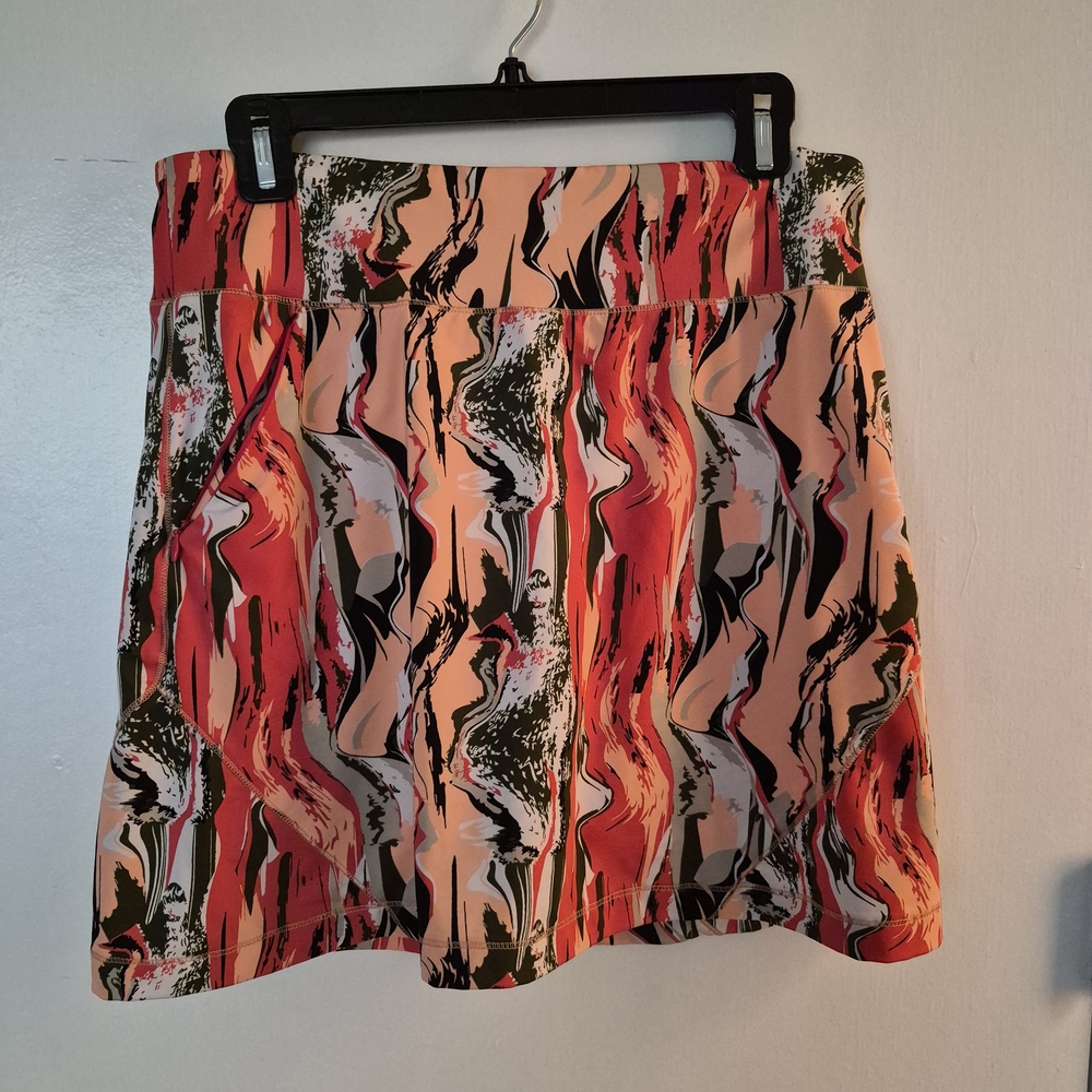 Chase 54 Golf Skort With Abstract Design In Coral and Olive.